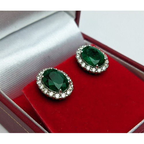 6 - A PAIR OF 18CT WHITE GOLD EMERALD AND DIAMOND STUD EARRINGS, the central emerald stones of 2.76 cara... 