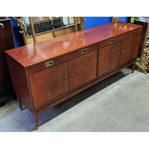 133 - SIDEBOARD, mid-century teak with two drawers above two cupboards, raised on brass caped tapered supp... 