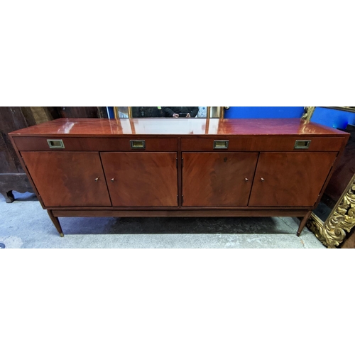 133 - SIDEBOARD, mid-century teak with two drawers above two cupboards, raised on brass caped tapered supp... 