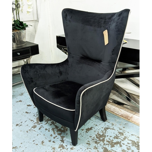 404 - WINGBACK ARMCHAIR, 82cm W, 1950s Italian style, black velvet upholstered, grey piping detail.