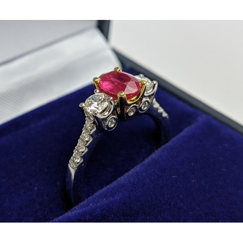15 - AN 18CT WHITE GOLD RUBY AND DIAMOND TRILOGY RING, the central ruby stone of approx. 0.89 carat, diam... 