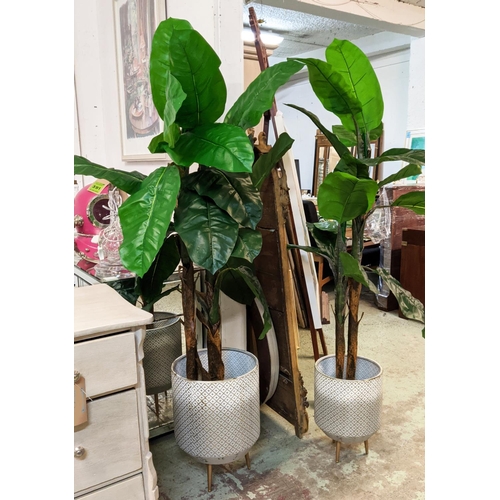 392 - FAUX BANANA PALMS, a pair, in painted metal containers, 177cm H at tallest approx. (2)