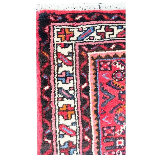 207A - LARGE PERSIAN HOSSEINABAD CRIMSON GROUND RUNNER, 514cm L x 84cm W.