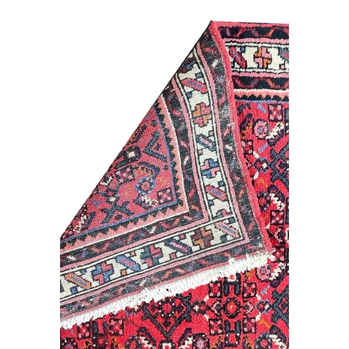 207A - LARGE PERSIAN HOSSEINABAD CRIMSON GROUND RUNNER, 514cm L x 84cm W.