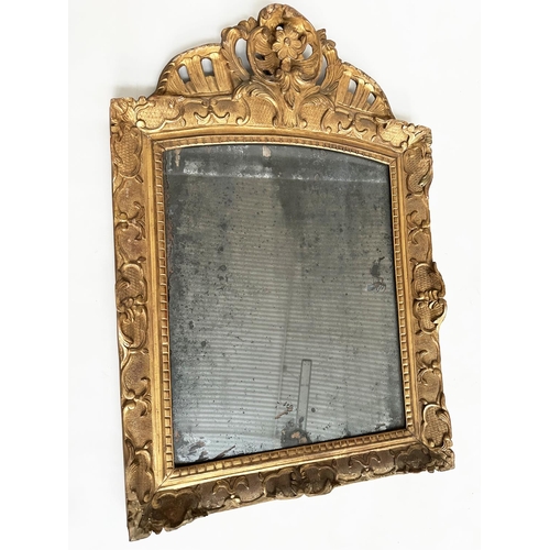241 - WALL MIRROR, late 18th century French carved giltwood and gesso with foliate crest and distressed ea... 