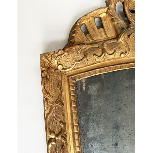 241 - WALL MIRROR, late 18th century French carved giltwood and gesso with foliate crest and distressed ea... 