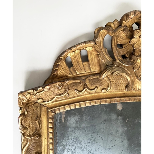 241 - WALL MIRROR, late 18th century French carved giltwood and gesso with foliate crest and distressed ea... 