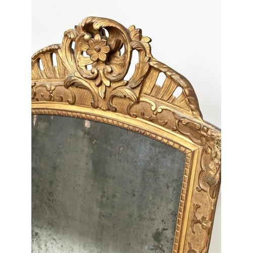 241 - WALL MIRROR, late 18th century French carved giltwood and gesso with foliate crest and distressed ea... 