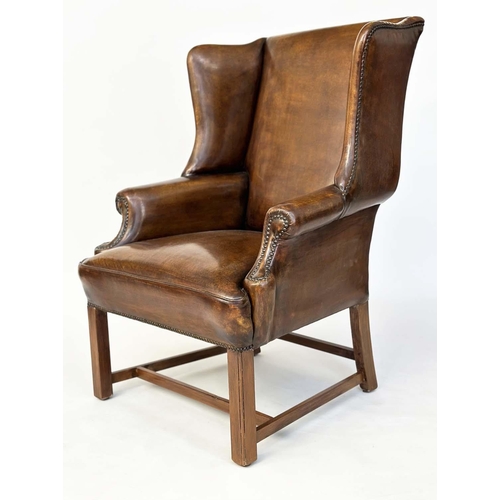 260 - WING ARMCHAIR, early George III design mahogany with brass studded naturally faded mid brown leather... 