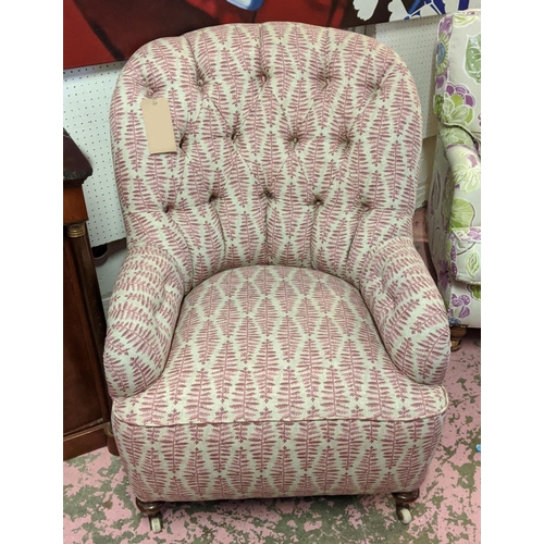 295 - ARMCHAIR, Victorian button back with turned front supports and castors, 93cm H x 69cm W.