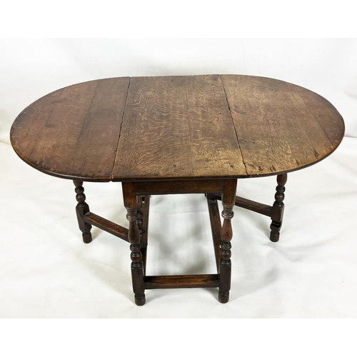 373 - AN OAK GATELEG DINING TABLE, traditionally made, oval top, turned supports, square stretchers, 72cm ... 