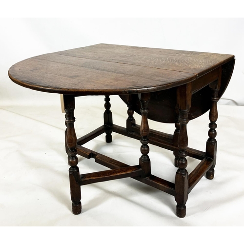 373 - AN OAK GATELEG DINING TABLE, traditionally made, oval top, turned supports, square stretchers, 72cm ... 