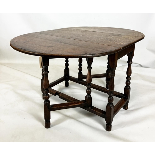 373 - AN OAK GATELEG DINING TABLE, traditionally made, oval top, turned supports, square stretchers, 72cm ... 