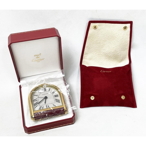 7 - CARTIER ROUIANE ALARM CLOCK, Must de Cartier, arched dial in gilt metal and red enamel case in origi... 