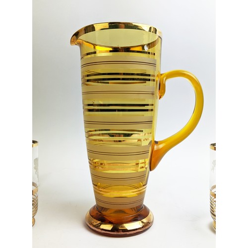 45 - A MID 20TH CENTURY ITALIAN AMBER COLOURED WINE JUG, and six beakers, the beakers with grapevine deco... 