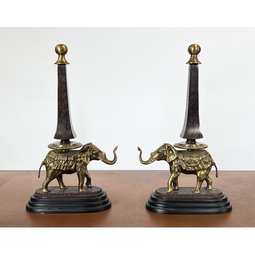 20 - ELEPHANT OBLISKS, a pair, gilt metal on a stepped ebonised base, 52cm H. (2)