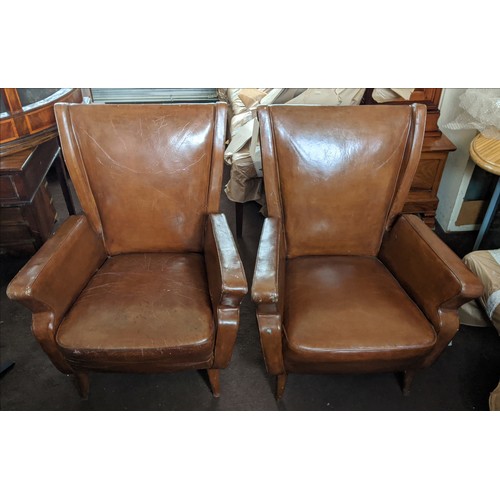 651 - ARMCHAIRS, a pair, tan leather, 88.5cm H x 68cm x 66cm. (2)