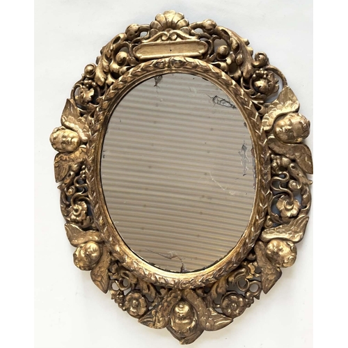 238 - WALL MIRROR, early 19th century Italian carved giltwood oval with carved cherubs and foliate detail,... 