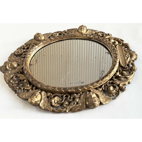 238 - WALL MIRROR, early 19th century Italian carved giltwood oval with carved cherubs and foliate detail,... 