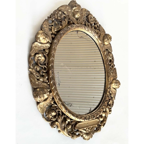 238 - WALL MIRROR, early 19th century Italian carved giltwood oval with carved cherubs and foliate detail,... 