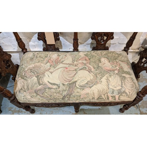 367 - A CONTINENTAL 19TH CENTURY WALNUT TWO SEATER HALL SEAT, cherub head decoration foliage carved rails,... 