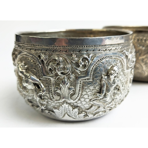 19 - A COLLECTION OF BURMESE/EASTERN SILVER PLATED ITEMS, comprising four heavily embossed bowls and a ju... 