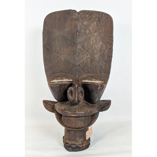 9 - BAMILEKE BATCHAM JANUS STOOL (Cameroon), 105cm H x 6cm W x 55cm D.