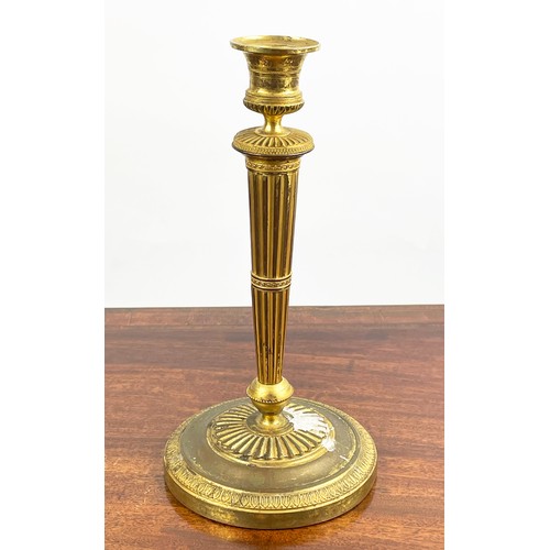 12 - CANDLESTICKS, a near pair, 19th century gilt brass, 27cm H. (2)