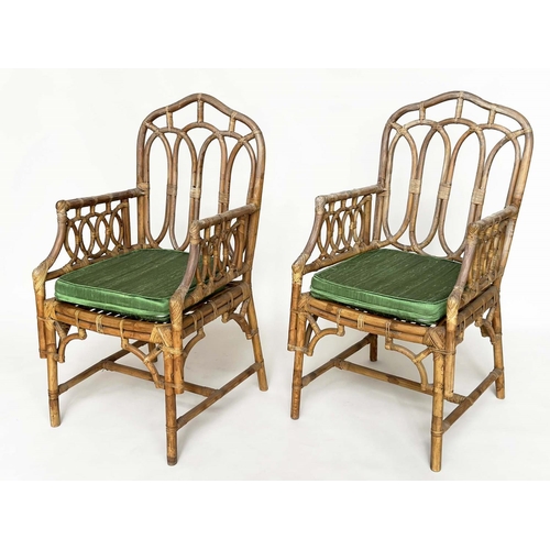 121 - CONSERVATORY ARMCHAIRS, a pair, vintage bamboo, rattan framed and cane bound with Gothic arched back... 