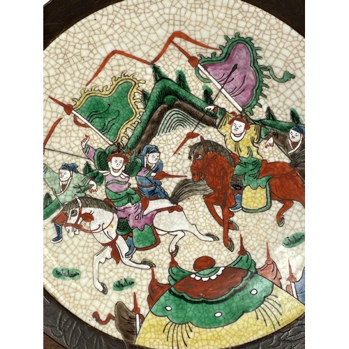 16 - CHINESE STONEWARE PLATE, decorated with battle scene in bright enamels, 33cm diam.