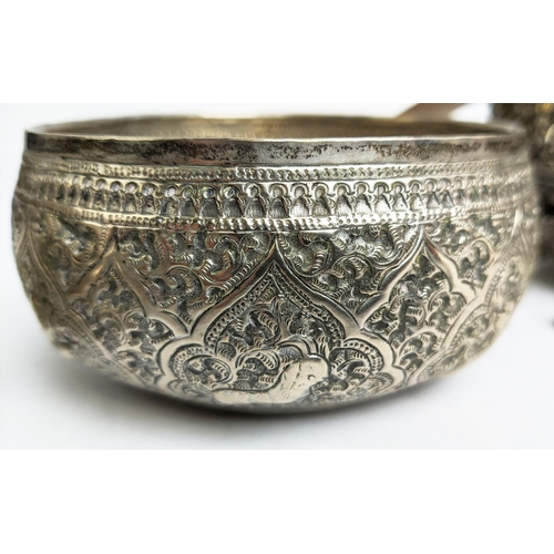 19 - A COLLECTION OF BURMESE/EASTERN SILVER PLATED ITEMS, comprising four heavily embossed bowls and a ju... 