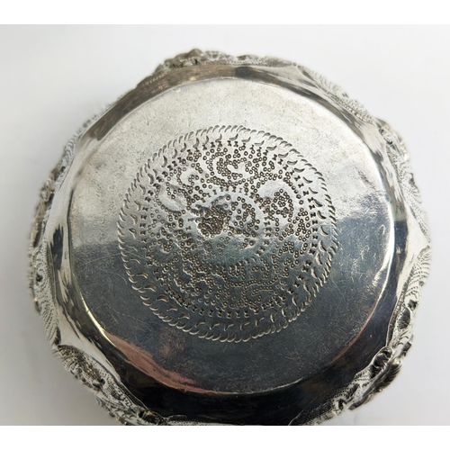 19 - A COLLECTION OF BURMESE/EASTERN SILVER PLATED ITEMS, comprising four heavily embossed bowls and a ju... 