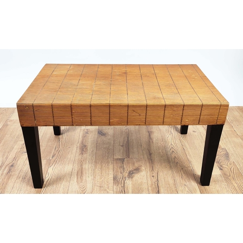 311 - COFFEE TABLE, rattan clad to on black painted legs, 174cm L x 42cm W x 40cm H.