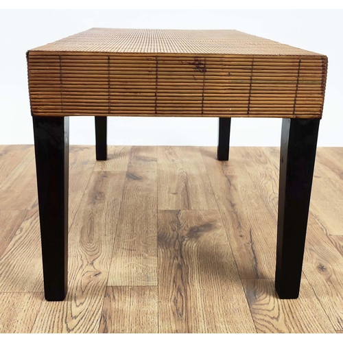 311 - COFFEE TABLE, rattan clad to on black painted legs, 174cm L x 42cm W x 40cm H.