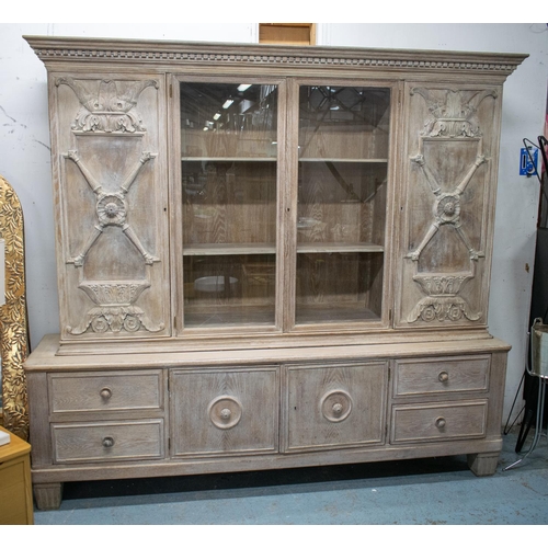 485 - BOOKCASE, 205cm H x 227cm W x 53cm D circa 1930, Danish limed oak with two glazed doors and carved p... 