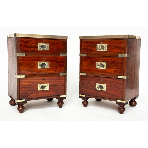 115 - CAMPAIGN CHESTS, a pair, mahogany and brass bound each with three drawers and turned supports, 44cm ... 