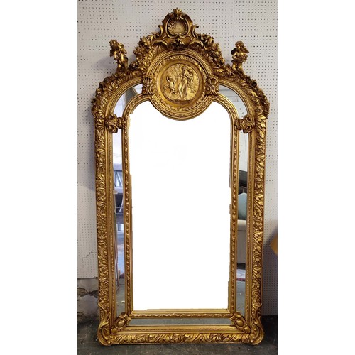 517 - WALL MIRROR, rococo style, giltwood frame, cherub finials and a shell and foliate surmount, classica... 