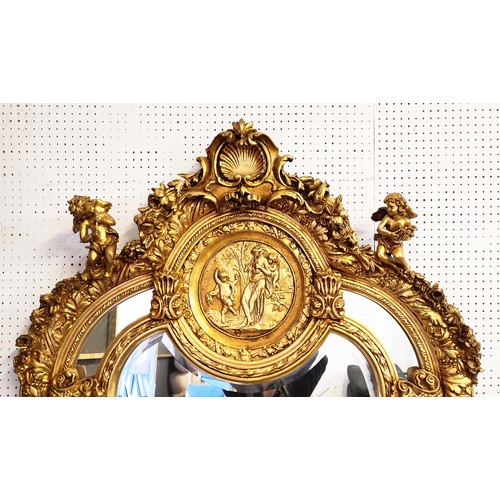 517 - WALL MIRROR, rococo style, giltwood frame, cherub finials and a shell and foliate surmount, classica... 