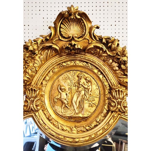 517 - WALL MIRROR, rococo style, giltwood frame, cherub finials and a shell and foliate surmount, classica... 