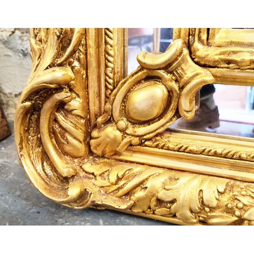 517 - WALL MIRROR, rococo style, giltwood frame, cherub finials and a shell and foliate surmount, classica... 