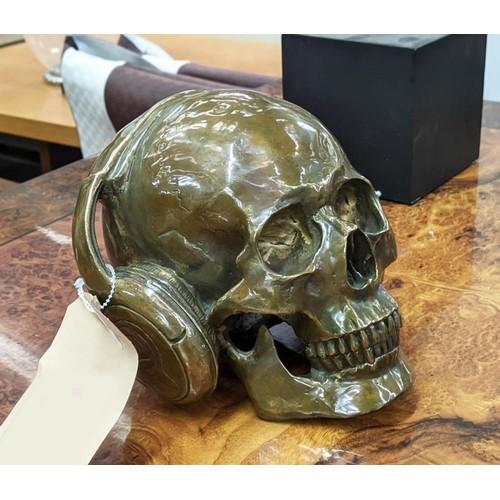 492 - CONTEMPORARY SCHOOL SCULPTURAL STUDY, DJ skull, bronzed metal, 17cm H.