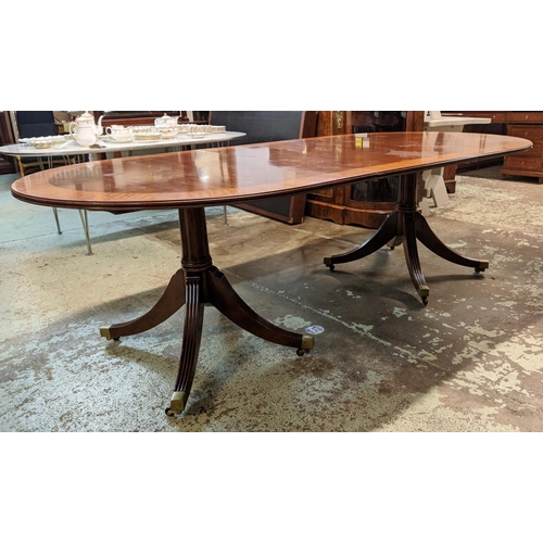 382 - DINING TABLE, Regency style mahogany with crossbanded detail, with two extra leaves on twin quadrafo... 