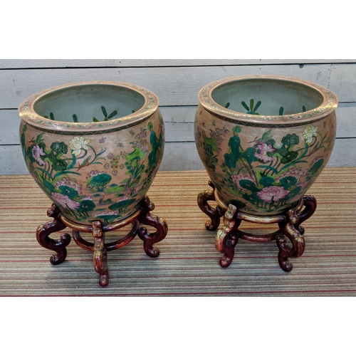 479 - PLANTERS ON STANDS, a pair, Chinese style ceramic, wooden stands, 72cm H x 55cm diam approx. (2)