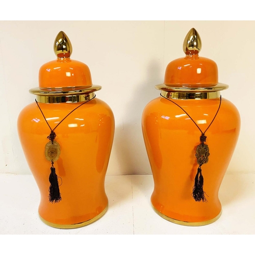 343 - TEMPLE JARS, a pair, 60cm high, 34cm diameter, glazed ceramic, orange body and gold rims. (2)