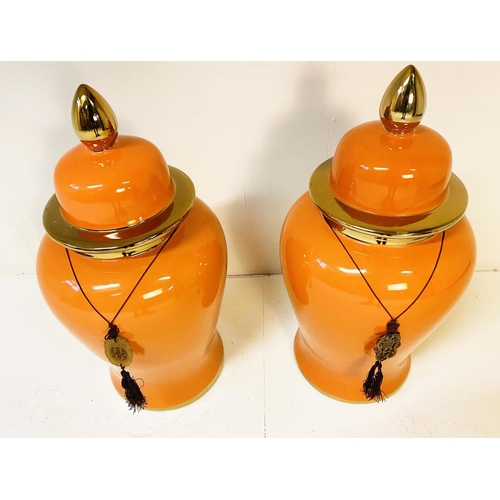 343 - TEMPLE JARS, a pair, 60cm high, 34cm diameter, glazed ceramic, orange body and gold rims. (2)