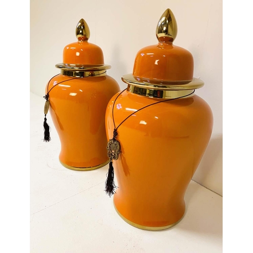 343 - TEMPLE JARS, a pair, 60cm high, 34cm diameter, glazed ceramic, orange body and gold rims. (2)