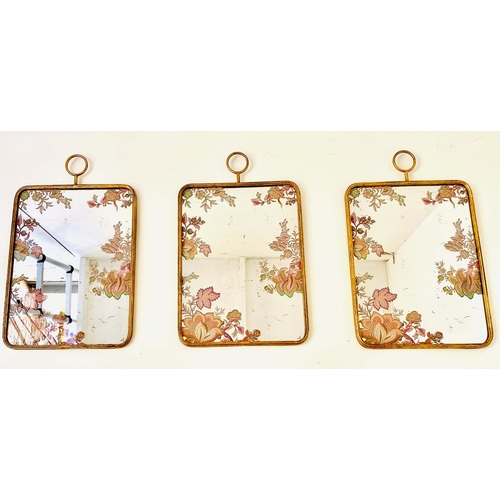 359 - WALL MIRRORS, a set of three, all with floral decoration, gilt frames, 64cm high, 40cm wide. (3)