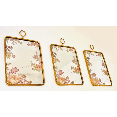 359 - WALL MIRRORS, a set of three, all with floral decoration, gilt frames, 64cm high, 40cm wide. (3)