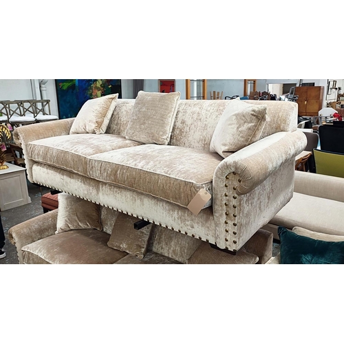 384 - SOFA , sand coloured fabric upholstery, gilt metal studded detail, 235cm W approx.