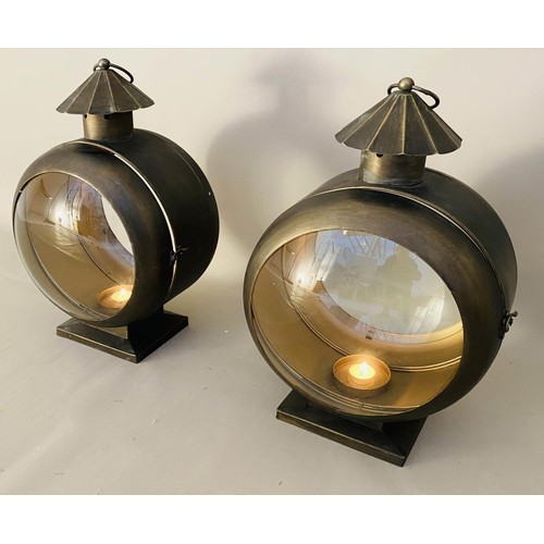 413 - STORM LANTERNS, a pair, convex glass, bronzed metal, 54cm x 37cm x 26cm. (2)